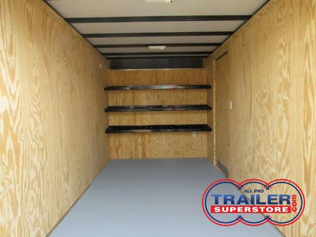 a very long empty room with wooden walls and shelves