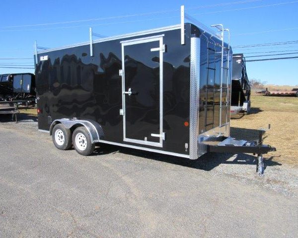 a black trailer parked on the side of the road