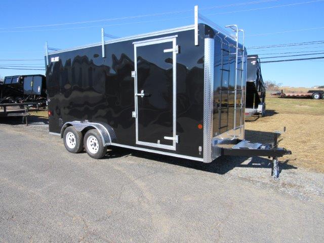 a black trailer parked on the side of the road