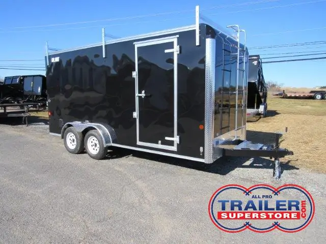 a black trailer parked on the side of the road