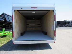 the back of a car mate trailer is open and empty .