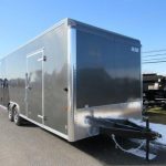 a gray trailer parked on the side of the road