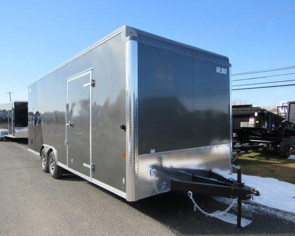 a gray trailer parked on the side of the road