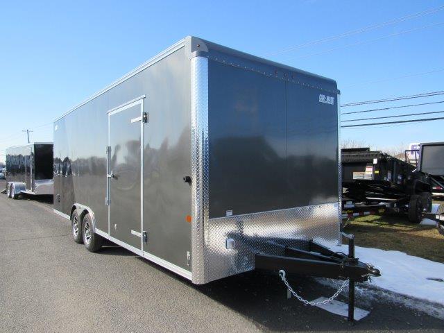 a gray trailer parked on the side of the road