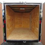 the inside of an empty trailer with the doors open
