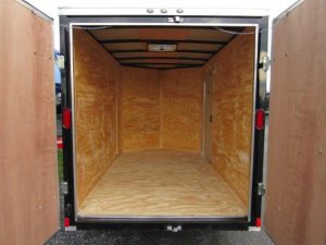the inside of an empty trailer with the doors open