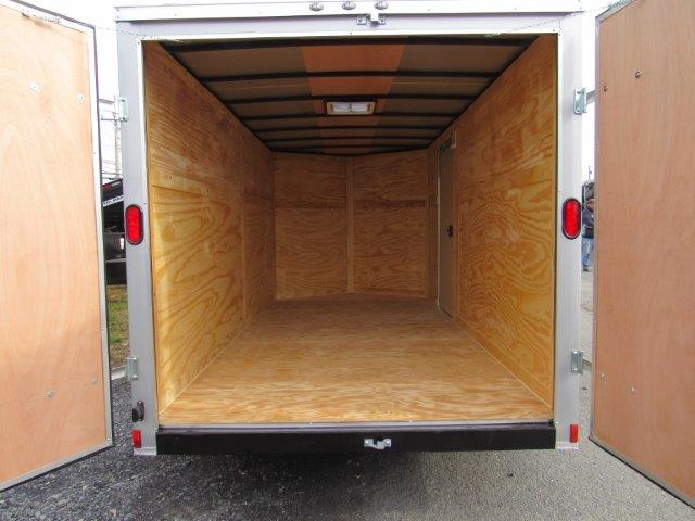 the inside of an empty Diamond Cargo trailer with the doors open