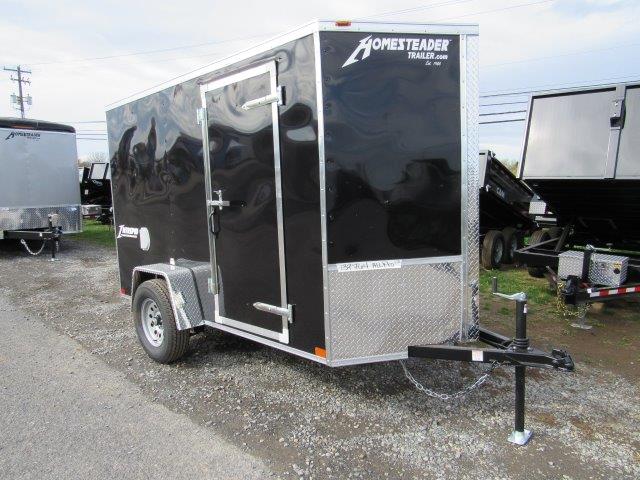 a black trailer parked on the side of the road