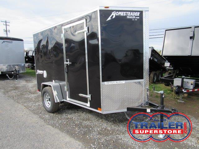 a black trailer parked on the side of the road