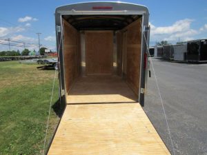 the inside of a Homesteader trailer with the door open and a wooden floor