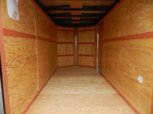 the interior of a Homesteader Nose Cargo trailer with barn doors and added height