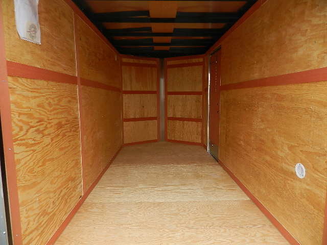 the interior of a Homesteader Nose Cargo trailer with barn doors and added height