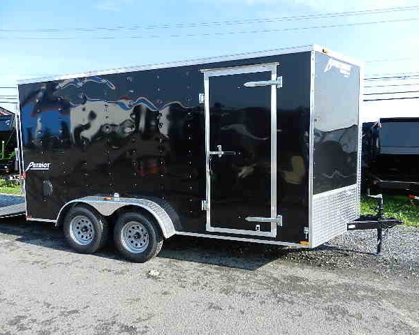 a black trailer parked on the side of the road