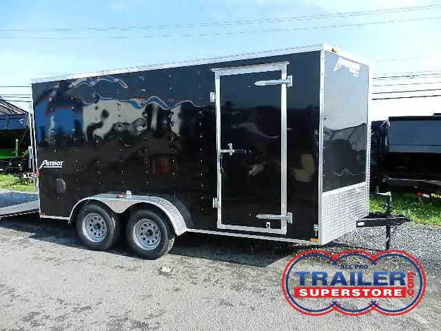 a black trailer parked on the side of the road