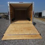 the back of a Homesteader trailer with the door open and a wooden floor