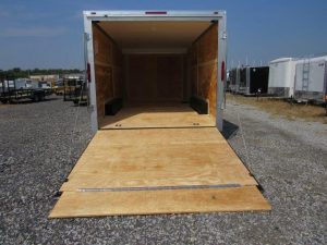 the back of a Homesteader trailer with the door open and a wooden floor