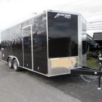a black trailer parked on the side of the road