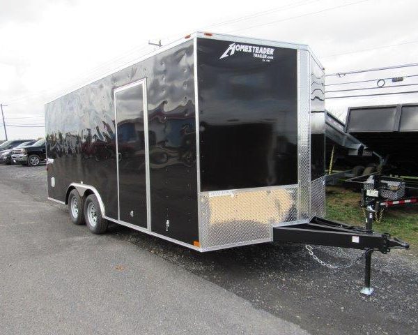 a black trailer parked on the side of the road