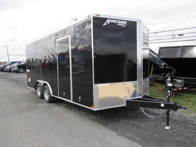 a black trailer parked on the side of the road