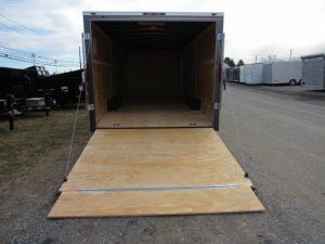 a trailer with a wooden floor is sitting on the side of a road