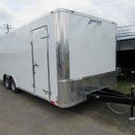 a white trailer parked on the side of the road