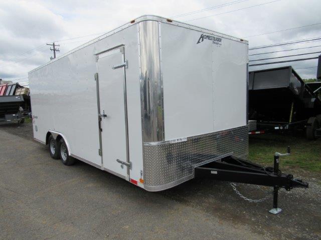 a white trailer parked on the side of the road