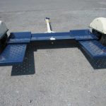 a blue and white trailer parked on concrete