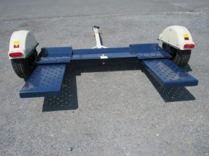 a blue and white trailer parked on concrete