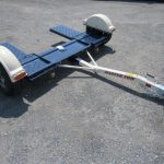 a Master Tow trailer sitting on a gravel road