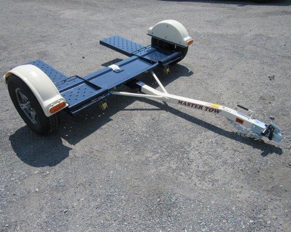 a Master Tow trailer sitting on a gravel road