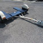 a master tow trailer is sitting on a gravel road
