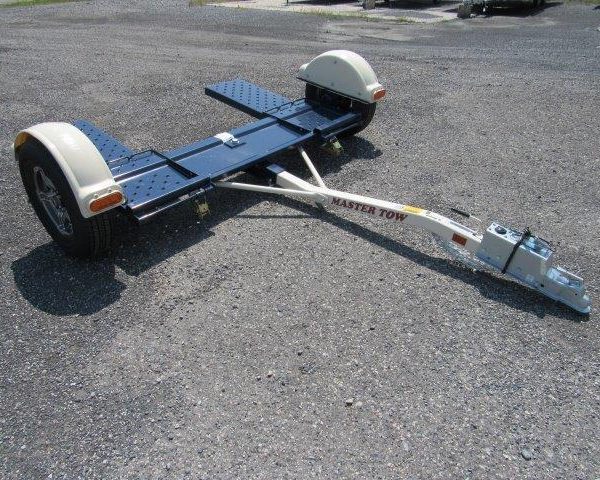 a master tow trailer is sitting on a gravel road