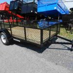 a premier trailer is parked on the side of the road .