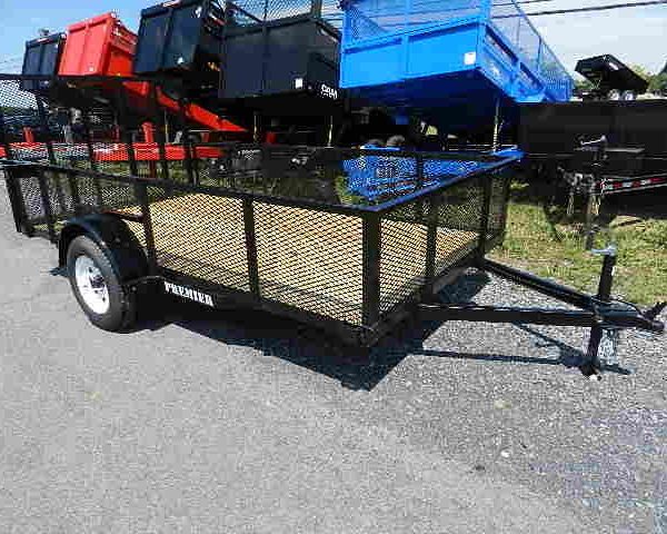 a premier trailer is parked on the side of the road .