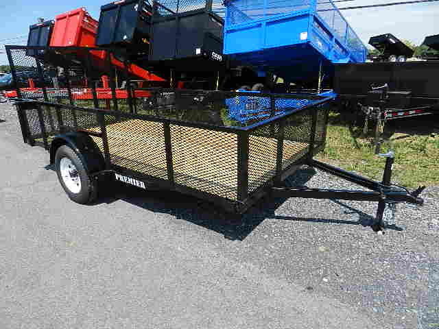 a premier trailer is parked on the side of the road .