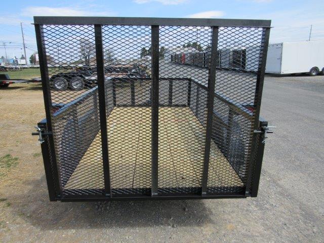 a trailer with a mesh gate is parked in a parking lot