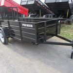 a black Premier landscape utility trailer with solid steel sides