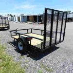 a Premier landscape utility trailer parked on a gravel road