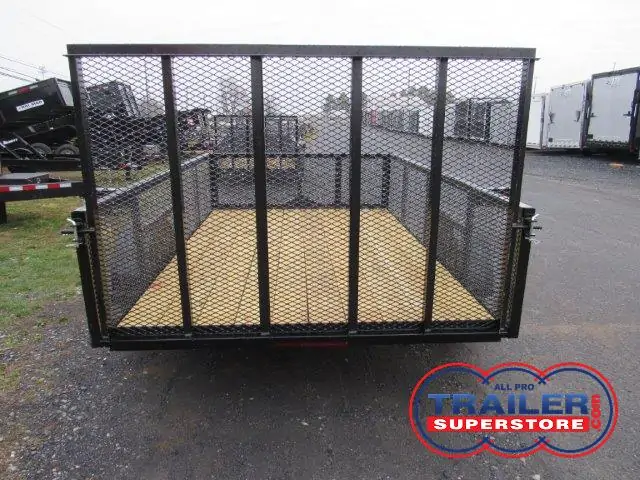 a Premier landscape utility trailer with mesh sides parked in a lot
