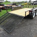 a trailer with a ramp is parked on the side of the road