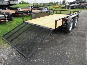a trailer with a ramp is parked on the side of the road