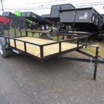 a Premier landscape utility trailer is parked on the side of a parking lot