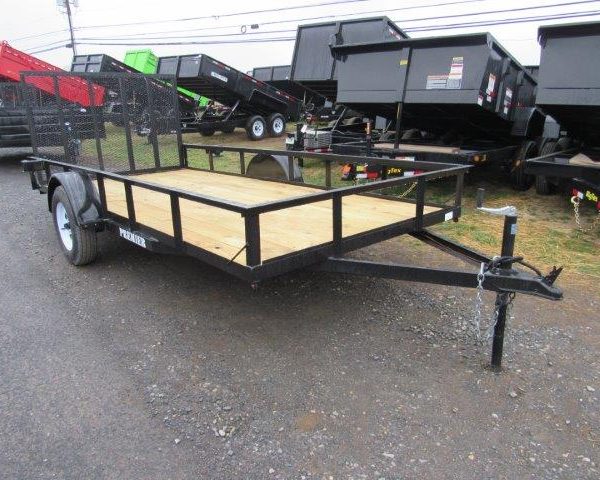 a Premier landscape utility trailer is parked on the side of a parking lot