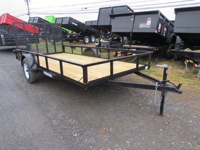 a Premier landscape utility trailer is parked on the side of a parking lot