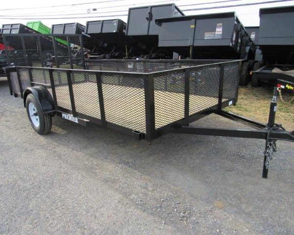 a trailer is parked on the side of the road next to a row of dump trailers