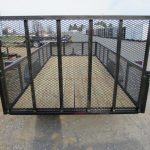 the back of a Premier trailer with a mesh fence and a wooden deck