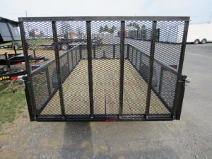 the back of a Premier trailer with a mesh fence and a wooden deck