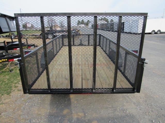 the back of a Premier trailer with a mesh fence and a wooden deck