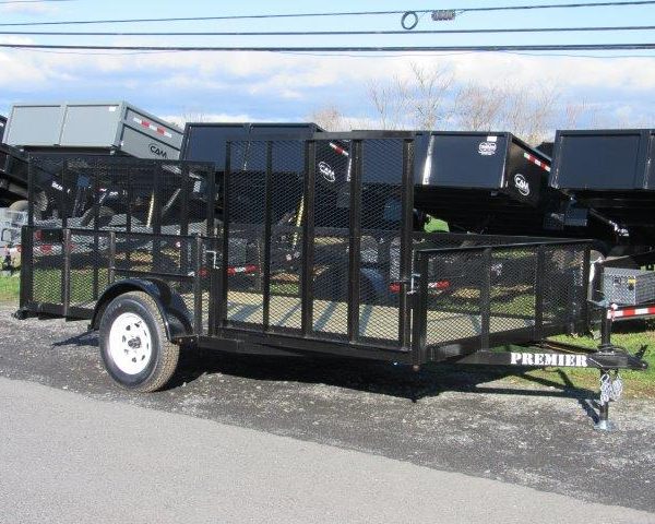 a black trailer is parked on the side of the road