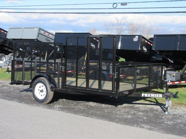 a black trailer is parked on the side of the road